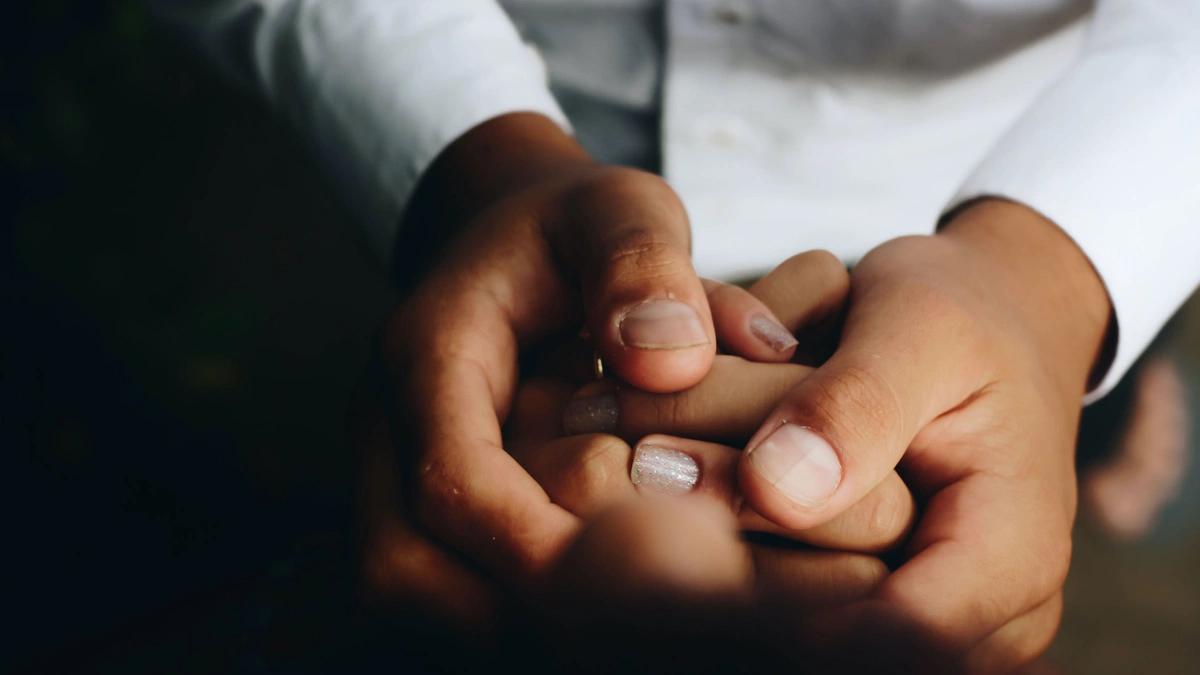 person holding both of someone's hands