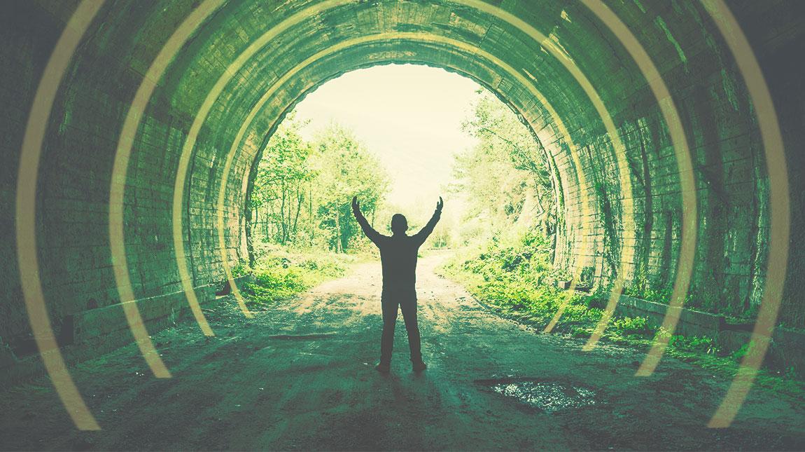 person with outstretched hands in a tunnel