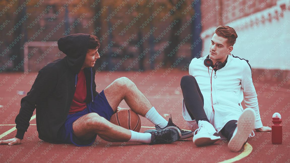 two guys sitting on a track